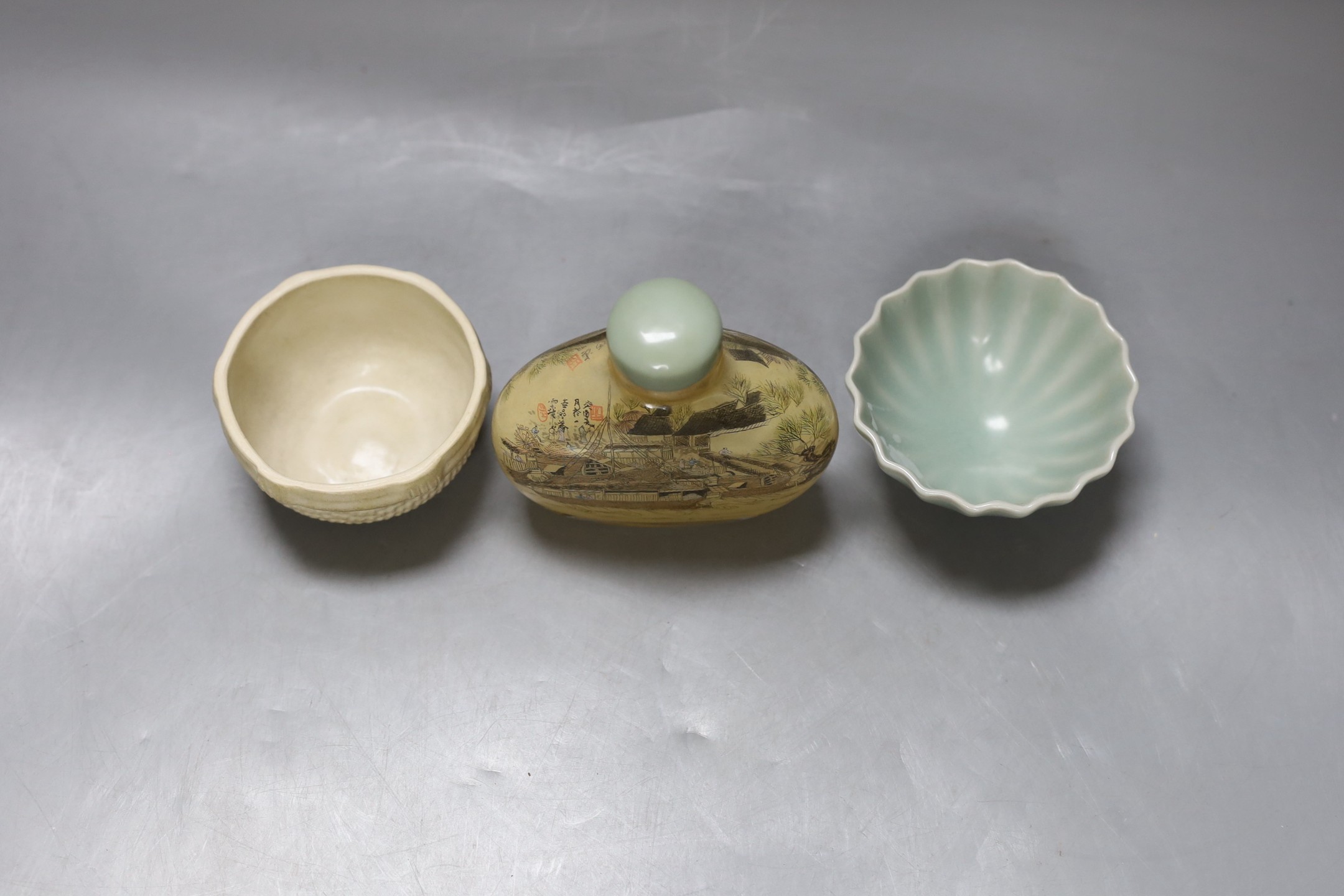 A Chinese inside-painted glass snuff bottle and cover, 10cm high, a Chinese Ming type basketware cup and a Chinese celadon fluted cup